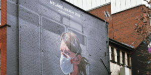 Portrait of NHS worker on wall