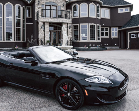 Exotic sportcar in the driveway of a mansion